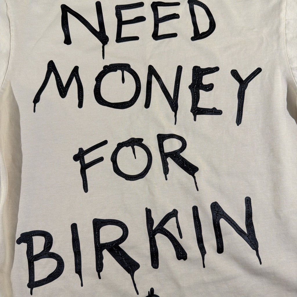 SMAKER cream-colored t-shirt features the graphics NEED MONEY FOR BIRKIN - Fashi