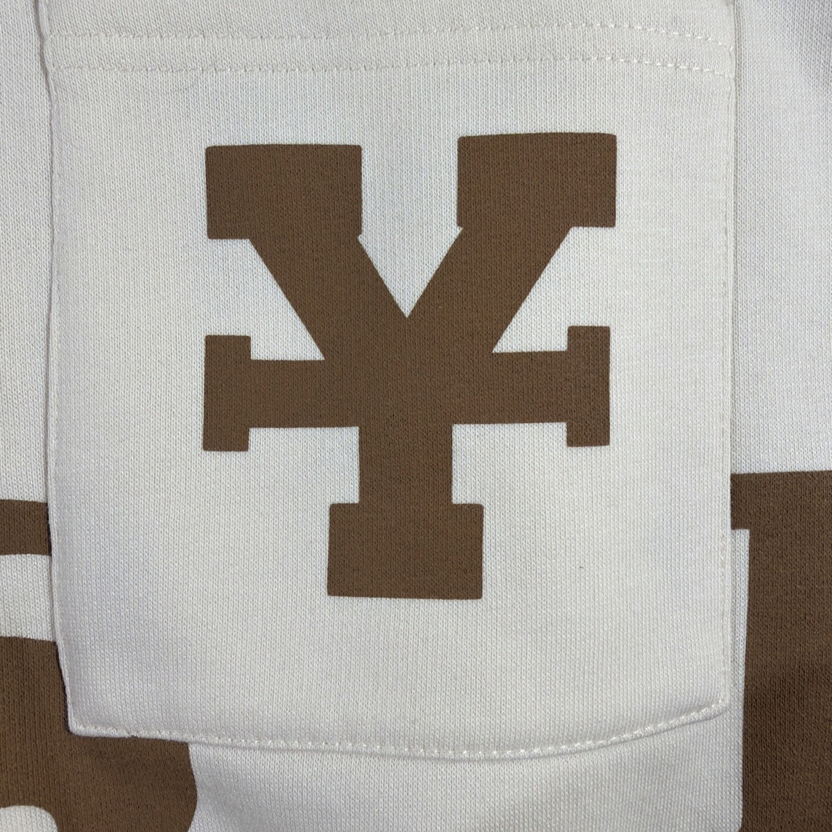 DirtyCoins brand cardigan featuring a distinctive all-over letter pattern