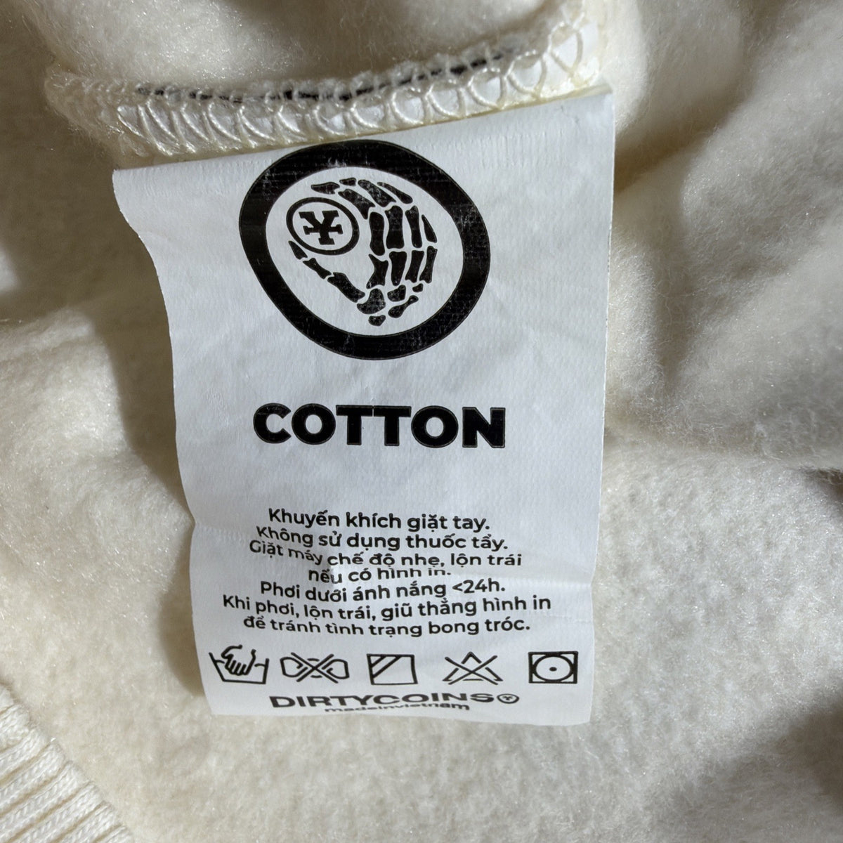 DirtyCoins brand cardigan featuring a distinctive all-over letter pattern